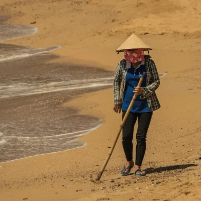woman cleaning beach
